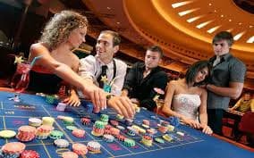 Casino live dealer table with multi-camera setup showing blackjack and roulette